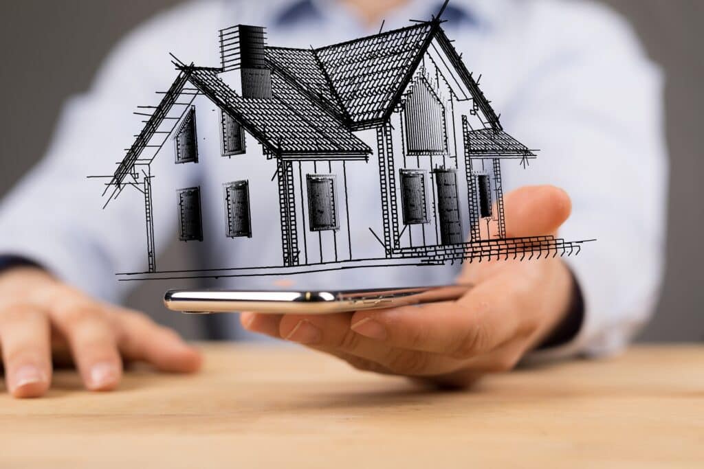 Skizze eines Hauses schwebt über Smartphone | Immobilienfinanzierung Duisburg